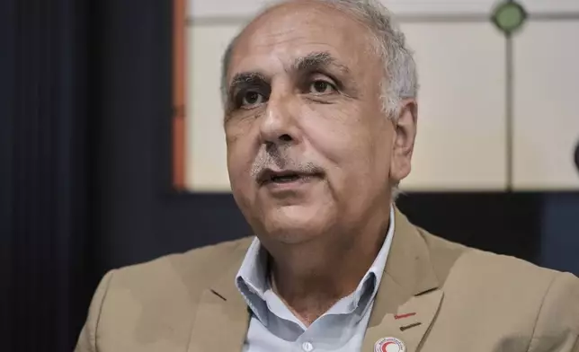 Dr. Mohammed Hazem Baqleh, president of the Syrian Arab Red Crescent, speaks during an interview with The Associated Press at the Habtoor Grand Hotel in the Sin el-Fil suburb of Beirut, Lebanon, Tuesday, July 22, 2025. (AP Photo/Bilal Hussein)