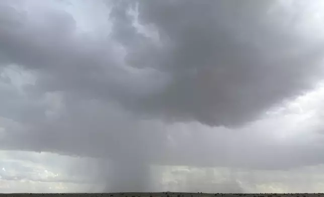 As the monsoon cranks up in the southwestern U.S., a rainstorm moves across the plains near Rio Rancho, New Mexico, on July 1, 2025. (AP Photo/Susan Montoya Bryan)