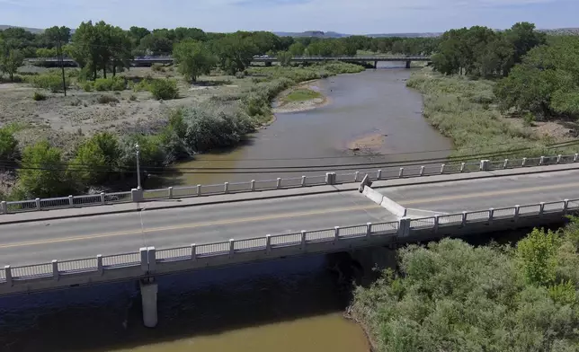 A historic bridge that crosses the Rio Grande is closed ahead of the monsoon due to concerns about a concrete pier being further scoured by high river flows in Española, New Mexico, on June 13, 2025. (AP Photo/Susan Montoya Bryan)