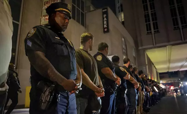 NYPD officers stand in line during the dignified transfer of Didarul Islam, who was shot and killed by a gunman Monday evening, out of NewYork-Presbyterian/Weill Cornell Medical Hospital to the medical examiner's office, early Tuesday, July 29, 2025, in New York. (AP Photo/Angelina Katsanis)