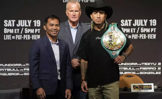 Manny Pacquiao, left, and WBC welterweight champion Mario Barrios pose at a news conference Wednesday, July 16, 2025, in Las Vegas. (AP Photo/John Locher)