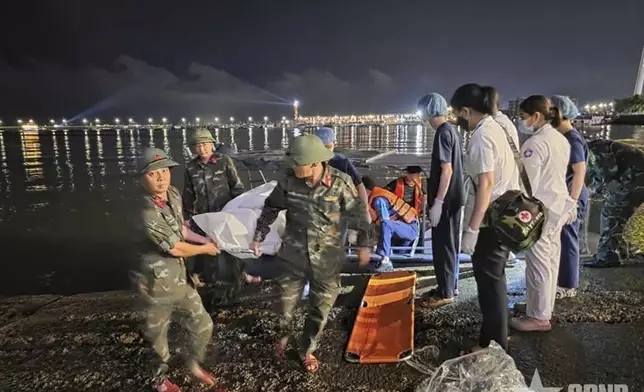 This image from a video provided by QDND shows a body being carried on stretcher after a tourist boat capsized in Ha Long Bay, Vietnam on Saturday, July 19, 2025. (QDND via AP)