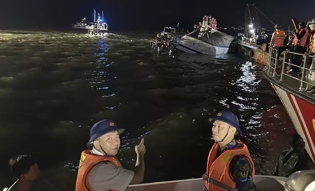 This image from a video provided by QDND shows rescue workers searching for people after a tourist boat capsized in Ha Long Bay, Vietnam on Saturday, July 19, 2025. (QDND via AP)