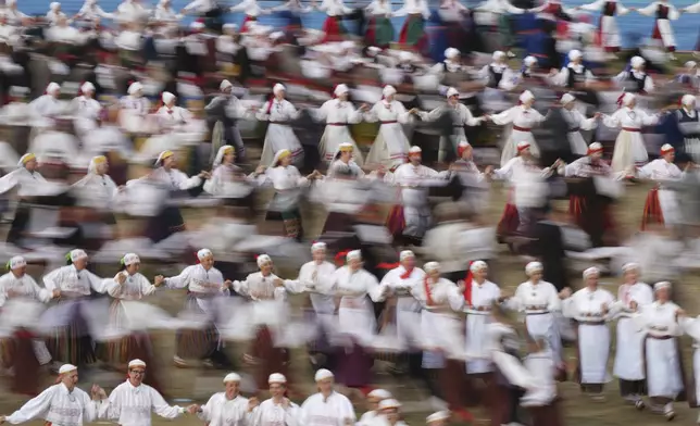 Participants perform during the Estonia Song and Dance Festivals at the Kalev stadium in Tallinn, Estonia, Thursday, July 3, 2025. (AP Photo/Sergei Grits)