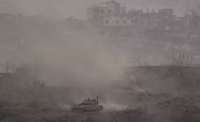 An Israeli army tank advances in the Gaza Strip, as seen from southern Israel on Thursday, July 3, 2025. (AP Photo/Leo Correa)