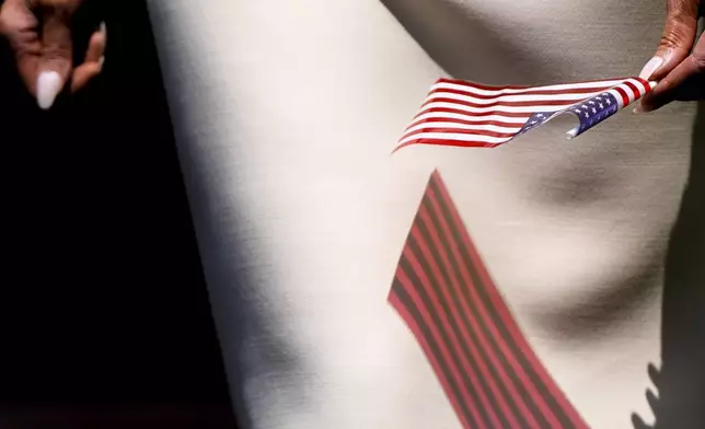 First lady Melania Trump holds an American flag while visiting Children's National Hospital, Thursday, July 3, 2025, in Washington. (AP Photo/Julia Demaree Nikhinson)