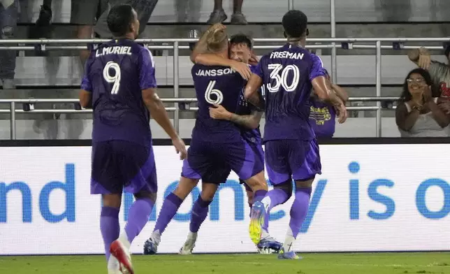 Orlando City defender Robin Jansson (6) celebrates his goal against New York City FCwith teammates including forward Luis Muriel (9) and defender Alex Freeman (30) during the first half of an MLS soccer match, Wednesday, July 16, 2025, in Orlando, Fla. (AP Photo/John Raoux)