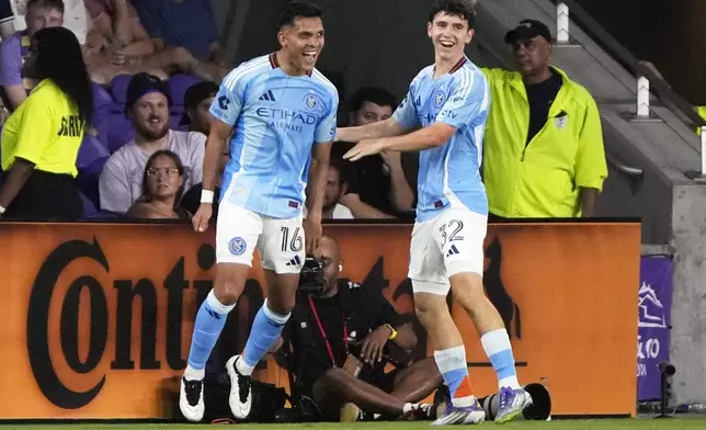 New York City FC forward Alonso Martinez (16) celebrates with teammate midfielder Jonathan Shore, right, after scoring the winning goal against Orlando City during the second half of an MLS soccer match, Wednesday, July 16, 2025, in Orlando, Fla. (AP Photo/John Raoux)