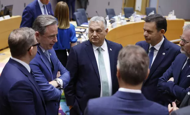 Clockwise from left, Finland's Prime Minister Petteri Orpo, Belgium's Prime Minister Bart De Wever, Hungary's Prime Minister Viktor Orban, Portugal's Prime Minister Luis Montenegro, Czech Republic's Prime Minister Petr Fiala, and Slovenia's Prime Minister Robert Golob attend a round table meeting at an EU summit in Brussels, Thursday, June 26, 2025. (AP Photo/Geert Vanden Wijngaert)