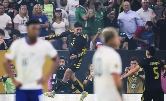 Mexico midfielder Edson Álvarez (4) leaps as he celebrates after scoring against the United States as Johan Vásquez (5) looks on in the second half of the CONCACAF Gold Cup final soccer match in Houston, Sunday, July 6, 2025. (AP Photo/David J. Phillip)