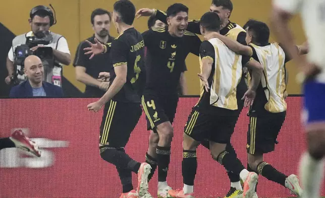Mexico midfielder Edson Álvarez (4) celebrates with teammates after scoring in the second half of the CONCACAF Gold Cup final soccer match against the United States in Houston, Sunday, July 6, 2025. (AP Photo/David J. Phillip)