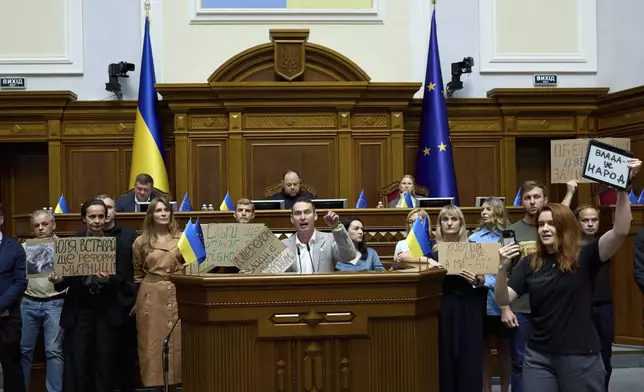 Ukrainian lawmakers are calling to vote for a new bill proposed by President Volodymyr Zelenskyy restoring the independence of the country's anti-corruption agencies at the parliament session hall in Kyiv, Ukraine, Thursday, July 31, 2025.(AP Photo/Vadym Sarakhan)