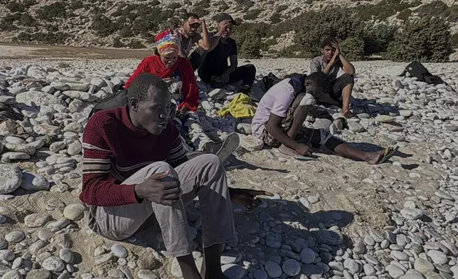 David, a migrant from South Sudan, sits at Tripiti beach with five others from a group of 68 migrants and refugees who arrived on the island of Gavdos, Greece, on Monday, July 7, 2025, as hundreds were rescued in recent days near the island and off Crete in separate incidents. (AP Photo/Elena Becatoros)