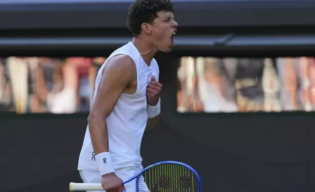 Ben Shelton of the U.S. celebrates winning the men's singles fourth round match against Lorenzo Sonego of Italy at the Wimbledon Tennis Championships in London, Monday, July 7, 2025.(AP Photo/Kirsty Wigglesworth)
