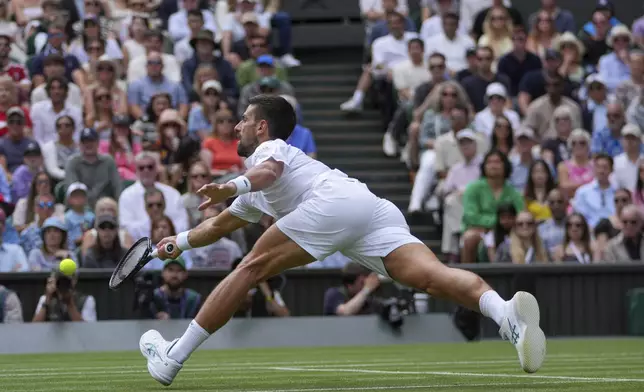 Serbia's Novak Djokovic returns to Australia's Alex de Minaur during a fourth round men's singles match at the Wimbledon Tennis Championships in London, Monday, July 7, 2025. (AP Photo/Kin Cheung)