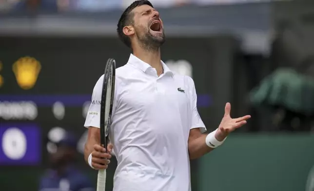 Serbia's Novak Djokovic reacts as he plays Australia's Alex de Minaur during a fourth round men's singles match at the Wimbledon Tennis Championships in London, Monday, July 7, 2025. (AP Photo/Kin Cheung)