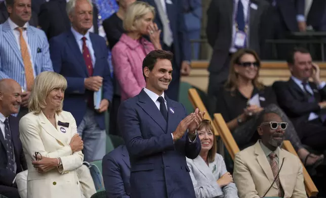 Tennis legend Roger Federer applauds after Serbia's Novak Djokovic beat Australia's Alex de Minaur during a fourth round men's singles match at the Wimbledon Tennis Championships in London, Monday, July 7, 2025. (AP Photo/Kin Cheung)