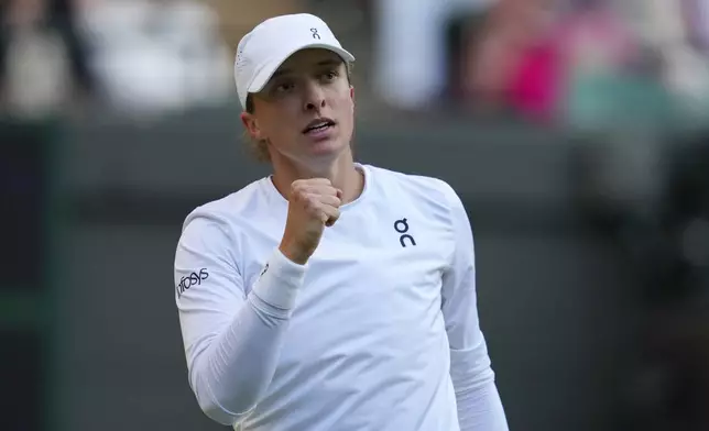 Iga Swiatek of Poland celebrates a point during the women's singles fourth round match against Clara Tauson of Denmark at the Wimbledon Tennis Championships in London, Monday, July 7, 2025.(AP Photo/Kirsty Wigglesworth)