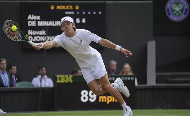 Australia's Alex de Minaur returns to Serbia's Novak Djokovic during a fourth round men's singles match at the Wimbledon Tennis Championships in London, Monday, July 7, 2025. (AP Photo/Kin Cheung)