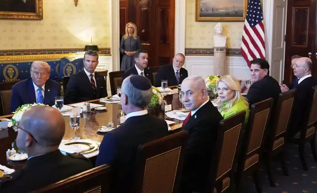 President Donald Trump, from back row left, Defense Secretary Pete Hegseth, CIA Director John Ratcliffe and U.S. Ambassador to Israel Mike Huckabee, meet with Israeli Ambassador to the U.S. Yechiel Leiter, front row from second left, Israel's Prime Minister Benjamin Netanyahu, Netanyahu's wife Sara Netanyahu, Israel's Strategic Affairs Minister Ron Dermer, Israel's National Security Council head Tzachi Hanegbi and Israel's Cabinet Secretary Yossi Fuchs in the Blue Room of the White House, Monday, July 7, 2025, in Washington. (AP Photo/Alex Brandon)