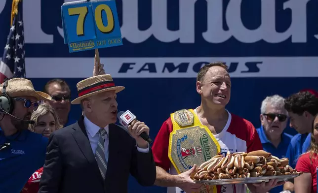 Competitive eater Joey Chestnut celebrates after winning the 2025 Nathan's Famous Fourth of July hot dog eating contest in the Coney Island section of the Brooklyn borough of New York, Thursday, July 4, 2025. (AP Photo/Yuki Iwamura)
