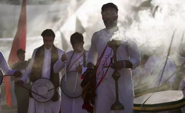 Shiite faithful worshippers gather between the holy shrines of Imam Hussein and Imam Abbas, during Muharram, a period of mourning for Shiites, in Karbala, Iraq, Saturday, July. 5, 2025. (AP Photo/Anmar Khalil)