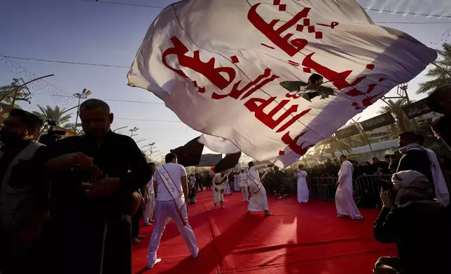 Shiite faithful worshippers gather between the holy shrines of Imam Hussein and Imam Abbas, during Muharram, a period of mourning for Shiites, in Karbala, Iraq, Saturday, July. 5, 2025. (AP Photo/Anmar Khalil)