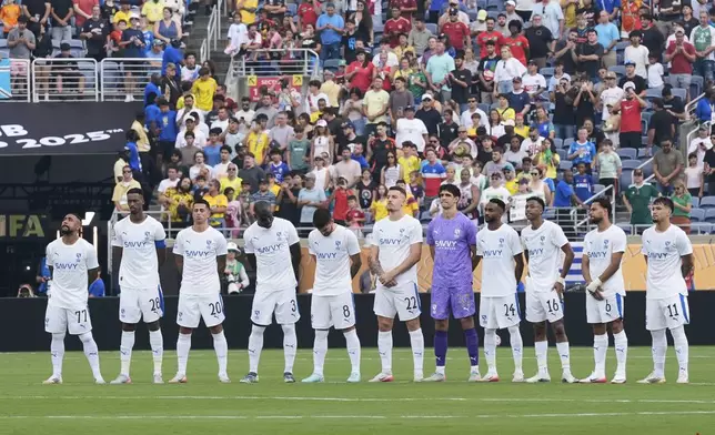 Players of the two teams observe a minute of silence in memory of Portugal international and Liverpool player Diogo Jota and his brother Andre Silva, before the Club World Cup quarterfinal soccer match between Fluminense and Al Hilal in Orlando, Fla., Friday, July 4, 2025. (AP Photo/John Raoux)