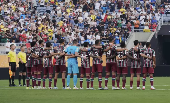 Players of the two teams observe a minute of silence in memory of Portugal international and Liverpool player Diogo Jota and his brother Andre Silva, before the Club World Cup quarterfinal soccer match between Fluminense and Al Hilal in Orlando, Fla., Friday, July 4, 2025. (AP Photo/John Raoux)