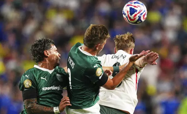 Chelsea's Liam Delap heads the ball with Palmeiras' Richard Rios and Palmeiras' Bruno Fuchs during the Club World Cup quarterfinal soccer match between Palmeiras and Chelsea in Philadelphia, Friday, July 4, 2025. (AP Photo/Derik Hamilton)