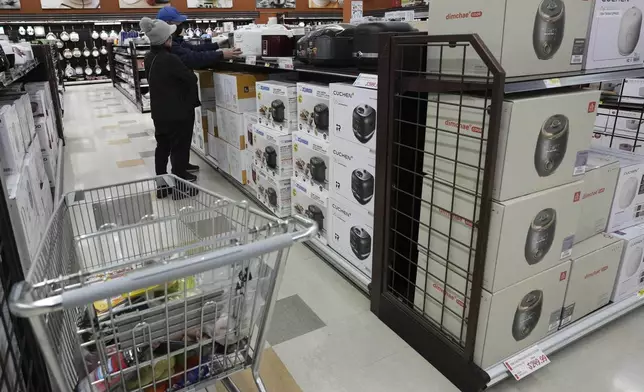 FILE - Shoppers shop electric rice cookers imported from Japan and Korea at the H Mart in Niles, Ill., April 3, 2025. (AP Photo/Nam Y. Huh, File)