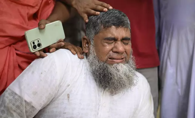 Shahbul, father of a missing girl student, cries after a Bangladesh Air Force training aircraft crashed into a school campus shortly after takeoff in Dhaka, Bangladesh, Monday, July 21, 2025. (AP Photo/Mahmud Hossain Opu)