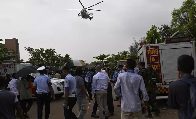A helicopter carrying injured victims of a Bangladesh Air Force training aircraft crash in Dhaka, Bangladesh, Monday, July 21, 2025. (AP Photo/Mahmud Hossain Opu)