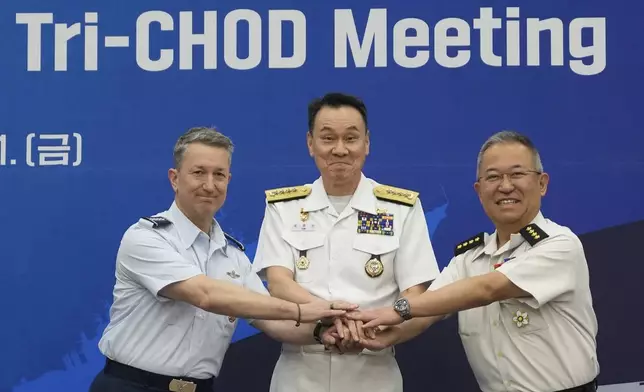 Gen, Yoshihide Yoshida, 1st right, Chief of Staff, Joint Staff of Japan, Adm. Kim Myung-soo, chairman of the South Korean Joint Chiefs of Staff, and John Daniel Caine, left, Chairman of the U.S. Joint Chiefs of Staff, pose during a Trilateral Chiefs of Defense meeting at the Defense Ministry in Seoul, South Korea, Friday, July 11, 2025. (AP Photo/Ahn Young-joon, Pool)