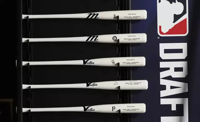 Specialized baseball bats are seen on display before the first round of the MLB baseball draft Sunday, July, 13, 2025 in Atlanta. (AP Photo/Mike Stewart)