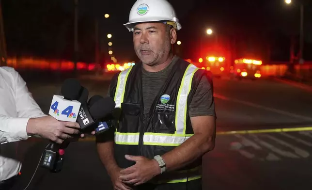 Los Angeles County Sanitation Districts Public Information Officer Michael Chee speaks to media after a tunnel collapsed on Wednesday, July 9, 2025, in Los Angeles. (AP Photo/Damian Dovarganes)