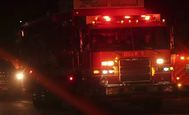 A Los Angeles Fire Department truck leaves after a tunnel collapsed on Wednesday, July 9, 2025, in Los Angeles. (AP Photo/Damian Dovarganes)
