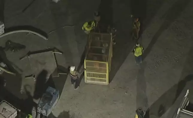 This image taken from footage provided by KABC/ABC7 Los Angeles shows first responders and workers after being lifted after a tunnel collapsed on Wednesday, July 9, 2025, in Los Angeles. (KABC/ABC7 Los Angeles via AP)