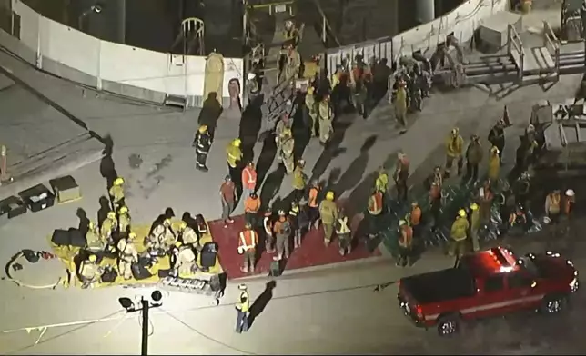 This image taken from footage provided by KABC/ABC7 Los Angeles shows first responders and rescued workers after a tunnel collapsed on Wednesday, July 9, 2025, in Los Angeles. (KABC/ABC7 Los Angeles via AP)
