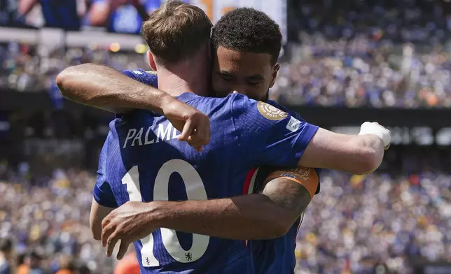 Chelsea's Cole Palmer, left, celebrates with teammates after scoring a goal against Paris Saint-Germain during the first half of the Club World Cup final soccer match in East Rutherford, N.J., Sunday, July 13, 2025. (AP Photo/Frank Franklin II)