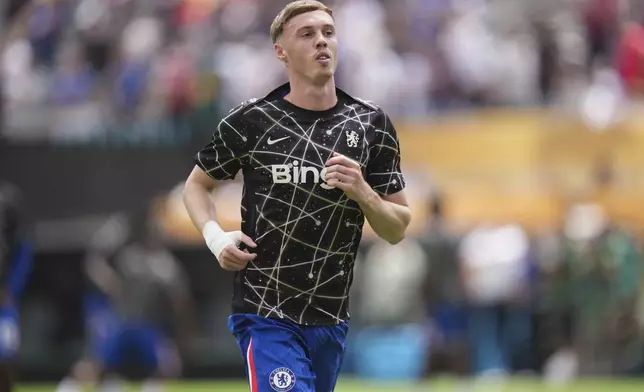 Chelsea's Cole Palmer warms up for the Club World Cup final soccer match between Chelsea and PSG in East Rutherford, N.J., Monday, July 14, 2025. (AP Photo/Chris Szagola)