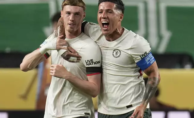 Chelsea's Cole Palmer, left, is congratulated by Enzo Fernandez after scoring his side's first goal against Palmeiras during the Club World Cup quarterfinal soccer match between Palmeiras and Chelsea in Philadelphia, Friday, July 4, 2025. (AP Photo/Chris Szagola)