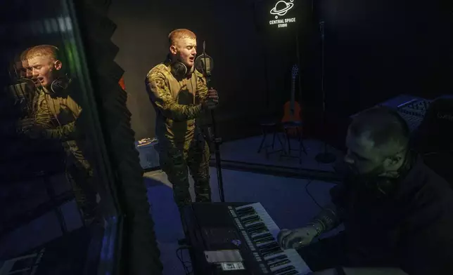 Ukrainian soldier Denys Zalizko, 21, sings a song at a recording studio in Kyiv, Ukraine, Tuesday, July 15, 2025. (AP Photo/Evgeniy Maloletka)