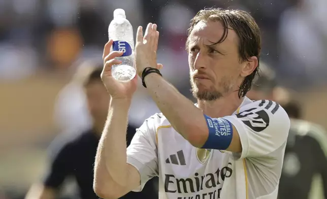 Real Madrid's Luka Modric applauds after the Club World Cup semifinal soccer match between PSG and Real Madrid in East Rutherford, N.J., Wednesday, July 9, 2025. (AP Photo/Adam Hunger)