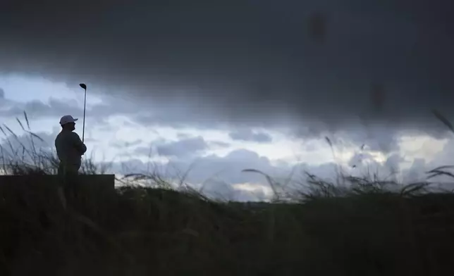 Chris Gotterup of the United States watches his drive off the 17th tee as rain storm moves in during the second round of the British Open golf championship at the Royal Portrush Golf Club, Northern Ireland, Friday, July 18, 2025. (AP Photo/Francisco Seco)