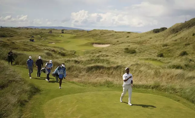Dylan Naidoo of South African, juggles the ball as he walk to the 7th tee during a practice round for the British Open golf championship at the Royal Portrush Golf Club, Northern Ireland, Monday, July 14, 2025. (AP Photo/Francisco Seco)