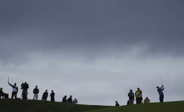 Justin Rose of England, right, plays a shot on the 17th hole during the first round of the British Open golf championship at the Royal Portrush Golf Club, Northern Ireland, Thursday, July 17, 2025. (AP Photo/Jon Super)