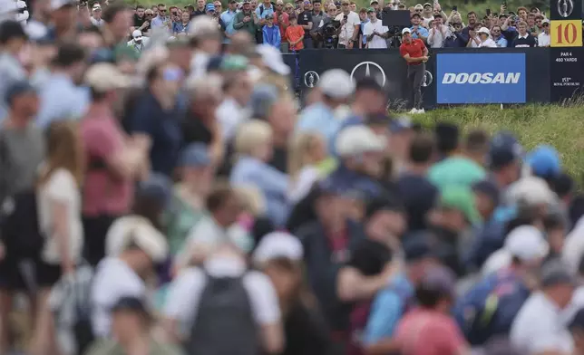 Rory McIlroy of Northern Ireland plays from he 10th tee watched by a large crowd during the third round of the British Open golf championship at the Royal Portrush Golf Club, Northern Ireland, Saturday, July 19, 2025. (AP Photo/Peter Morrison)