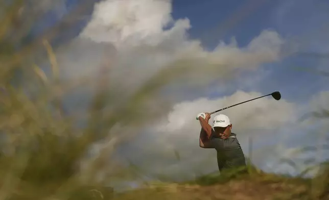 Li Haotong of China plays off the 12th tee during the third round of the British Open golf championship at the Royal Portrush Golf Club, Northern Ireland, Saturday, July 19, 2025. (AP Photo/Francisco Seco)