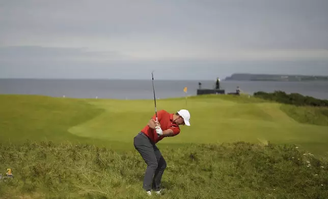 Rory McIlroy of Northern Ireland plays out of the rough on the 5th hole during the third round of the British Open golf championship at the Royal Portrush Golf Club, Northern Ireland, Saturday, July 19, 2025. (AP Photo/Francisco Seco)